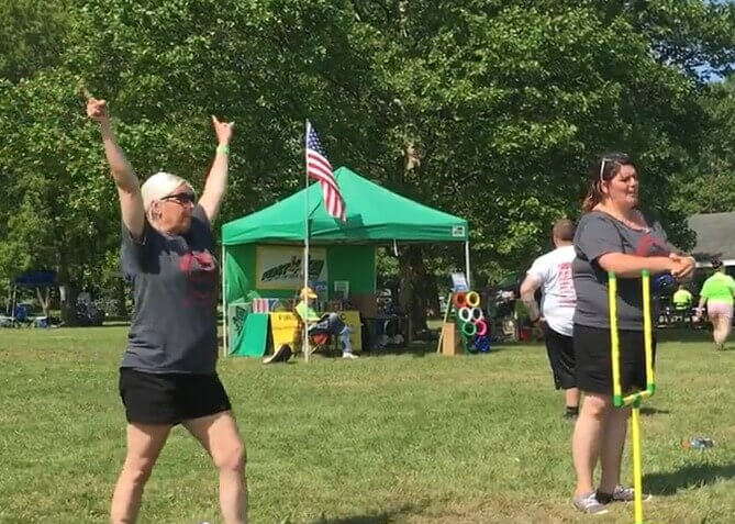 Two women playing First-N-Ten in a park on a sunny day