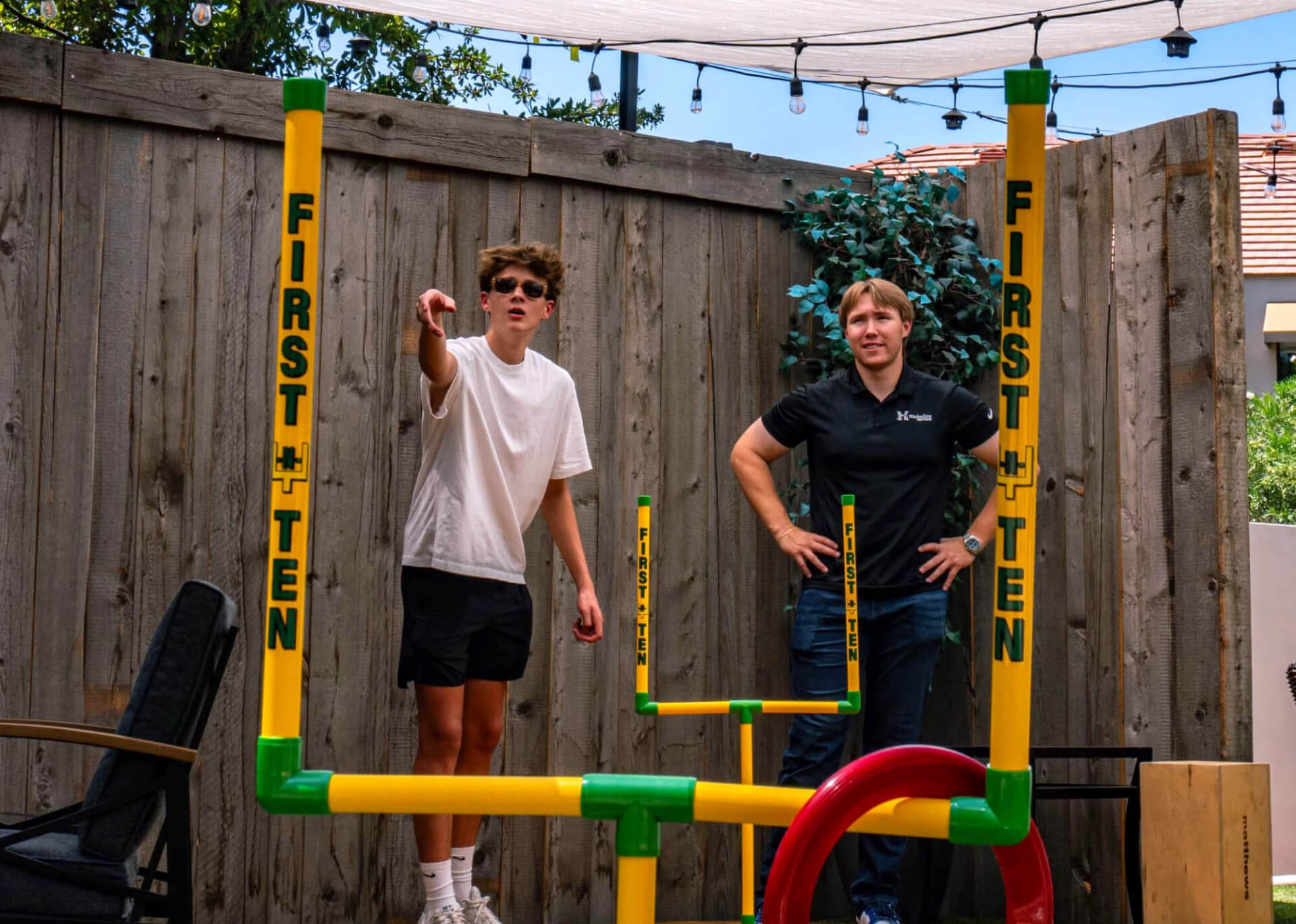 Two friends playing First-N-Ten in a yard